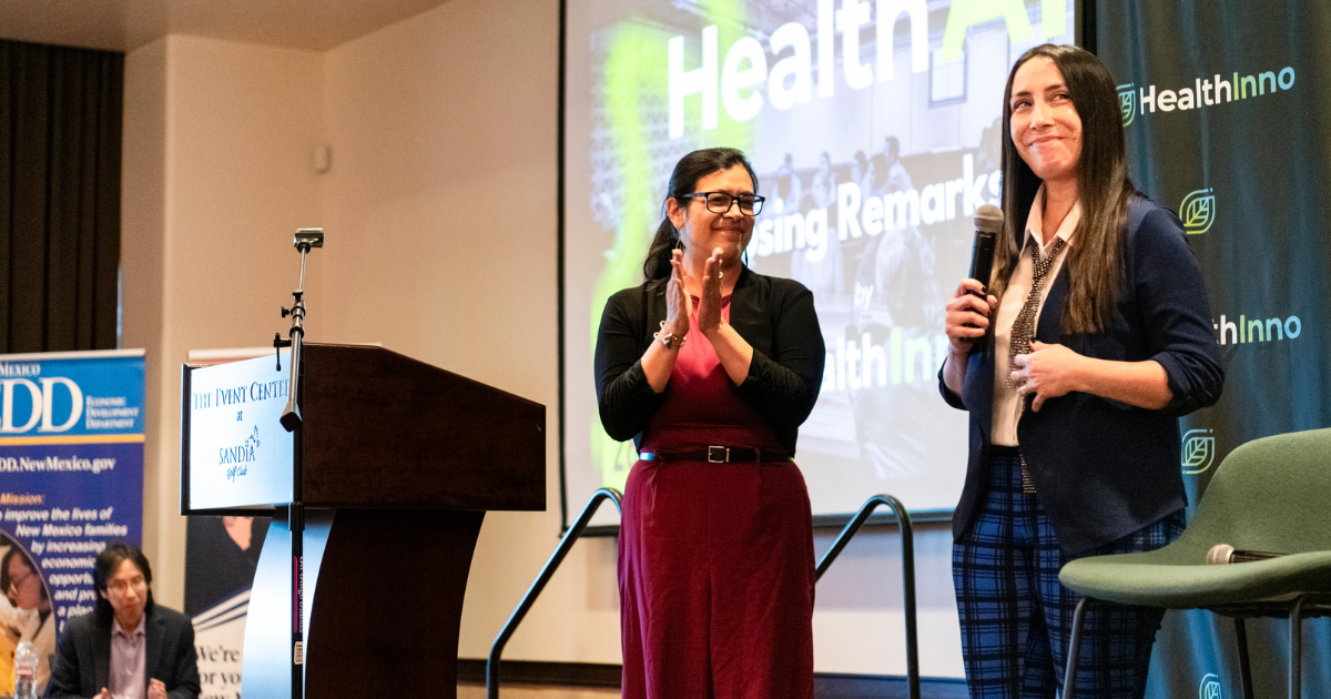 The HealthAI Summit 2026 opening on stage at the Embassy Suites in Albuquerque, with a Welcome to HealthAI slide presented by HealthInno